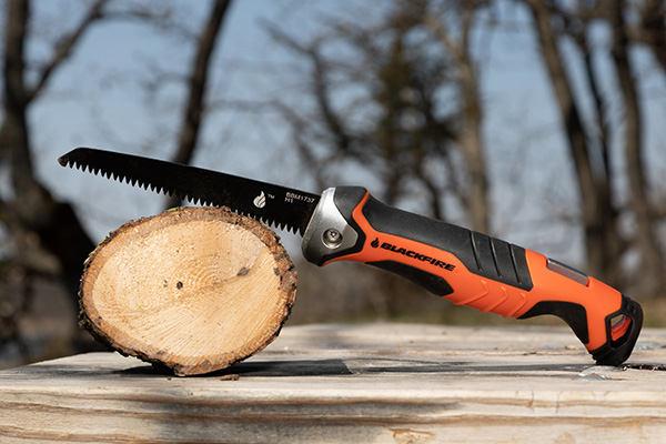 Blackfire Folding Saw Resting over 5 inch log that it cut